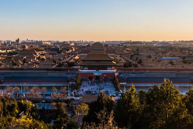 The golden roofs of the Forbidden City seen from Jingshan Hill at sunset, with the Gate of Divine Prowess in the centre.