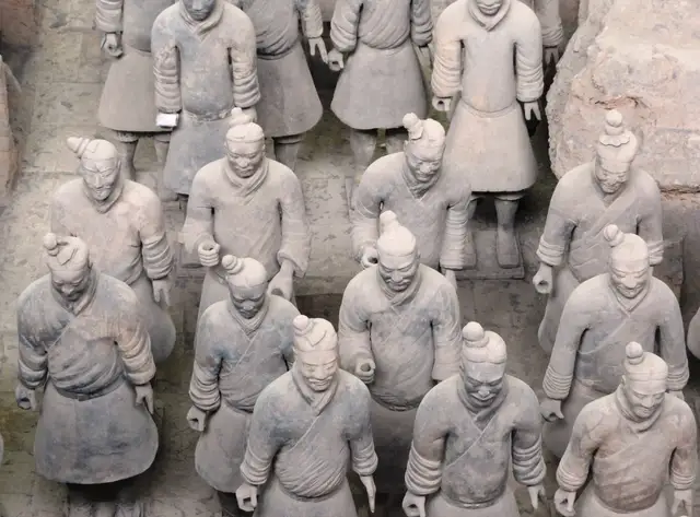 Terracotta warriors standing in rows, seen from above at close range.